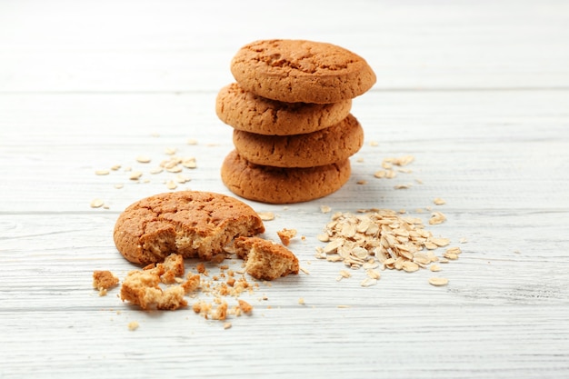 Delicious oatmeal cookies on white wooden table, closeup