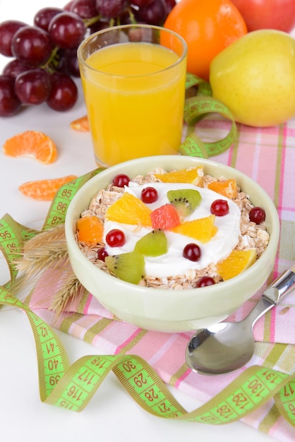 Delicious oatmeal with fruit in bowl on table closeup