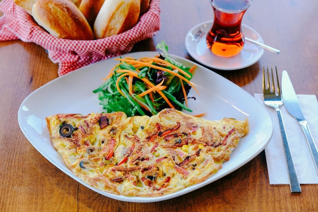 Delicious omlette and breakfast plate on the table.