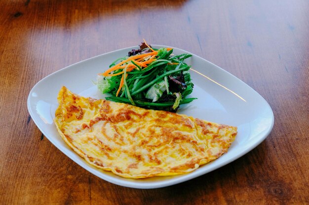 Delicious omlette and breakfast plate on the table.