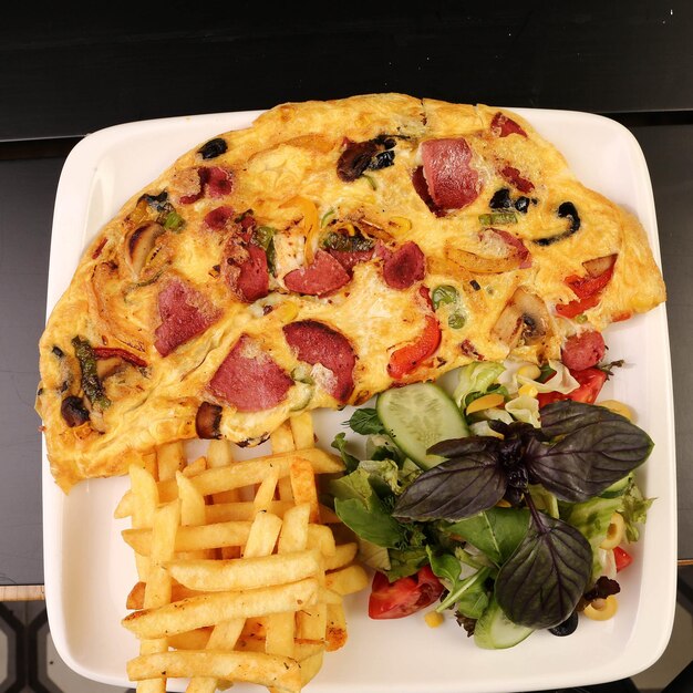 Delicious omlette and breakfast plate on the table.