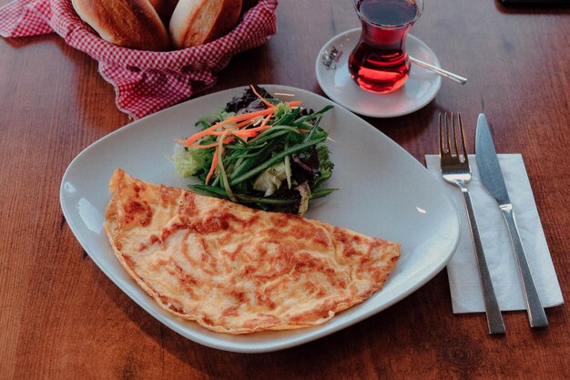 Delicious omlette and breakfast plate on the table.