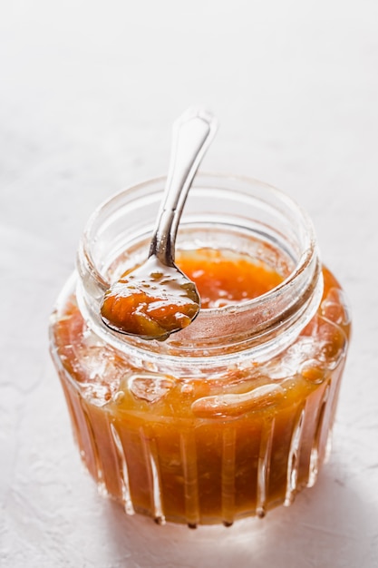 Delicious orange jam in a glass jar