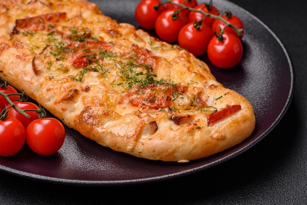 Delicious oven fresh flatbread pizza with cheese tomatoes sausage salt and spices