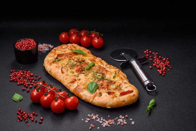 Delicious oven fresh flatbread pizza with cheese tomatoes sausage salt and spices