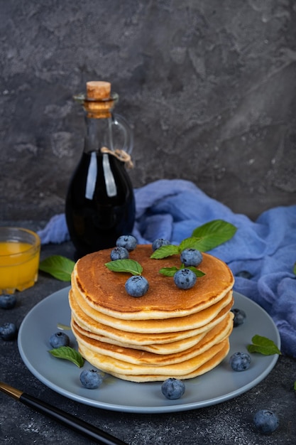 Delicious pancakes with blueberries and honey Sweet pancakes with fresh berries