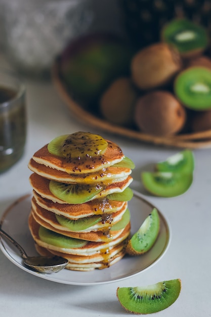 Delicious pancakes with kiwi on a plate