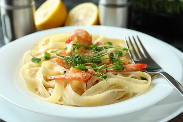 Delicious pasta with tasty shrimps, close up