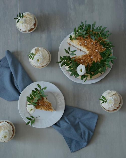 Delicious pastries decorated with flowers and greenery