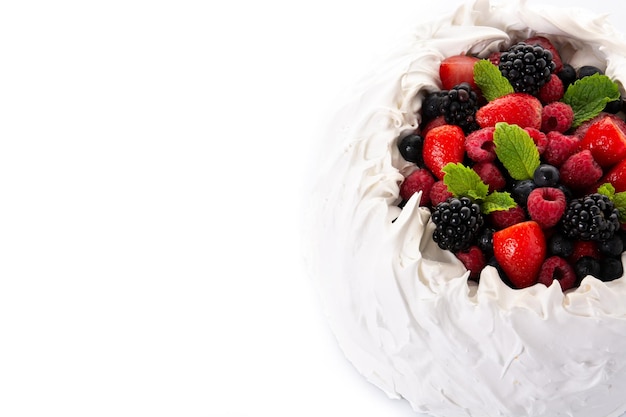 Delicious Pavlova cake with meringue topped and fresh berries isolated on white background