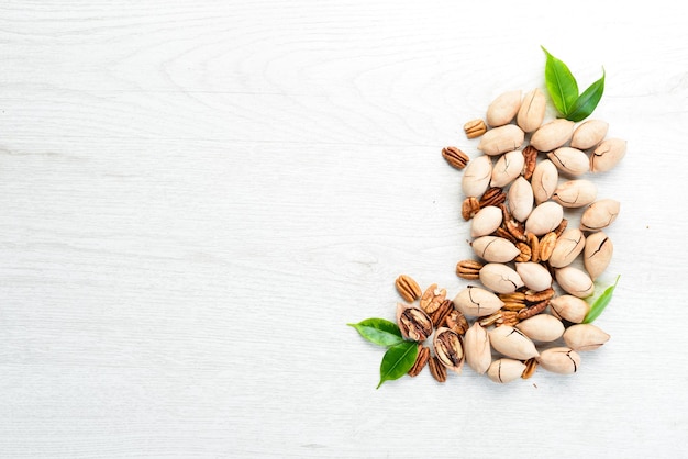 Delicious Pecan nuts on white background Wooden Top view Free space for your text