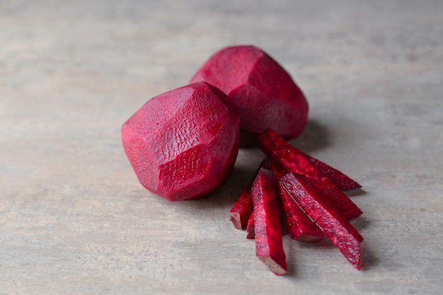 Delicious peeled and sliced ripe beets on table