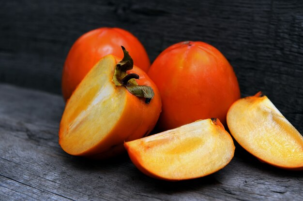 Delicious persimmons on wooden 