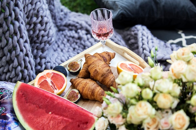 Delicious picnic with croissant and fruits