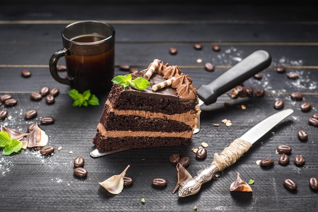 Delicious piece of chocolate cake with layers on the black background