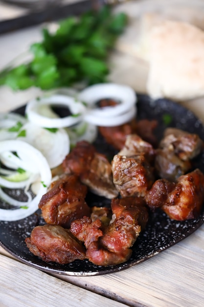 Delicious pieces of meat with onion rings