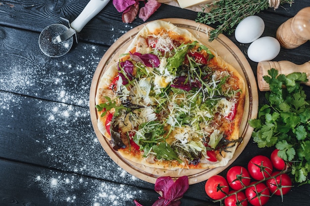 Delicious pizza on dark wooden background