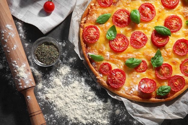 Delicious pizza on kitchen table