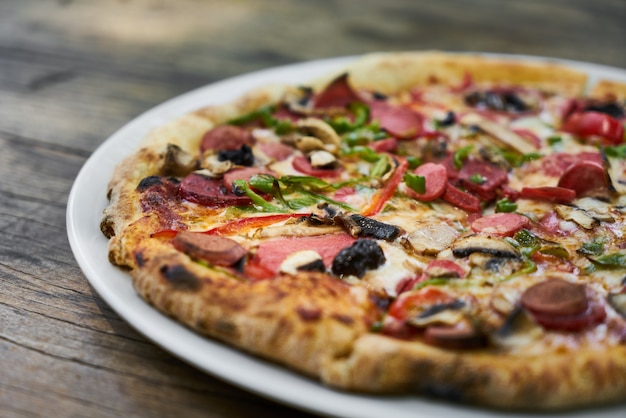 Delicious pizza served on porcelain plate