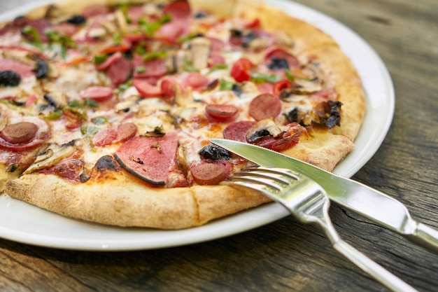 Delicious pizza served on porcelain plate