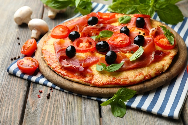 Delicious pizza served on wooden table