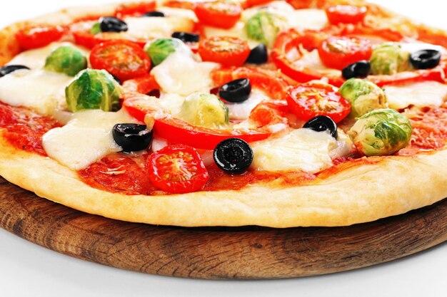 Delicious pizza with cheese and vegetables on wooden cutting board closeup