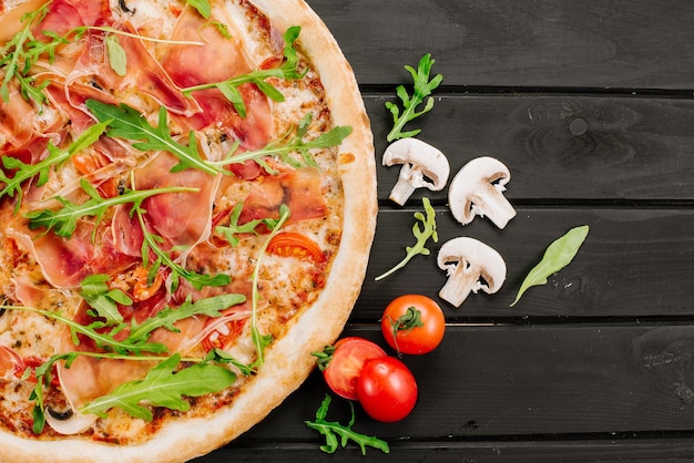 Delicious pizza with ham and cheese on wooden background