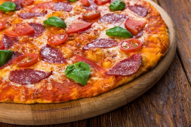 Delicious pizza with salami and cherry tomatoes