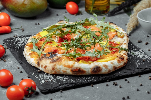 Delicious pizza with salmon and vegetables italian pizza