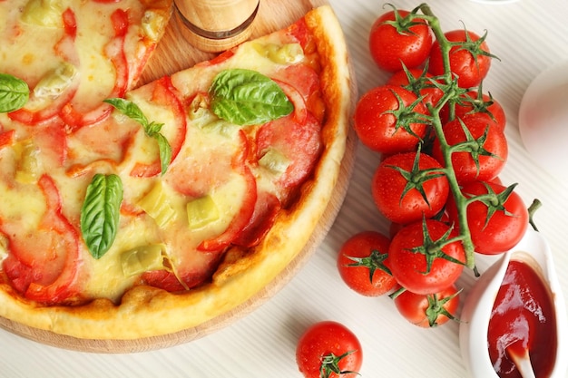 Delicious pizza on wooden cutting board