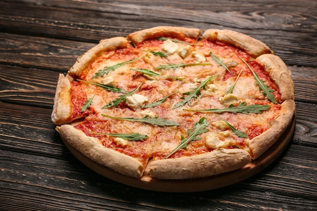 Delicious pizza on wooden table