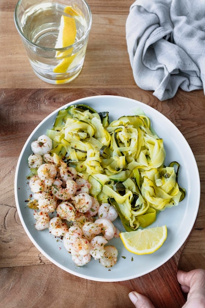 Delicious plate of zucchini spaghetti with lemon and butter prawns Delicious and healthy food