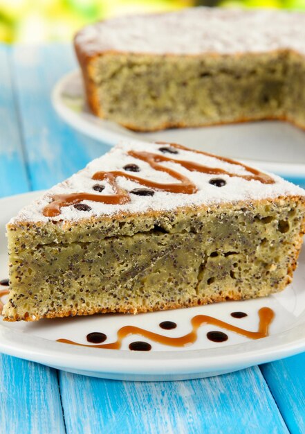 Delicious poppy seed cake on table closeup