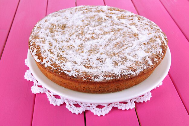 Delicious poppy seed cake on table closeup