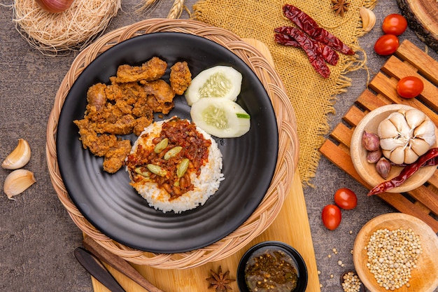 delicious pork belly rice or samcan goreng with rice combined with baby squid and petai Its characteristic food from North Sumatra  Medan