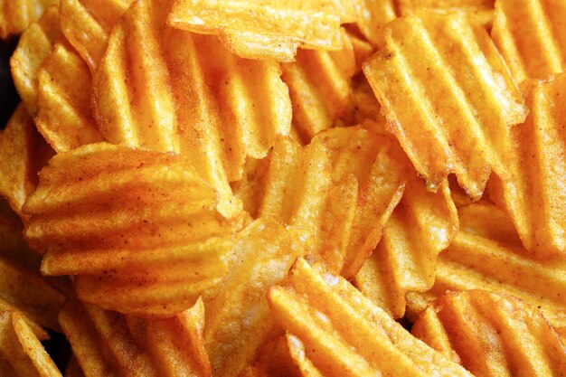 Delicious potato chips closeup background