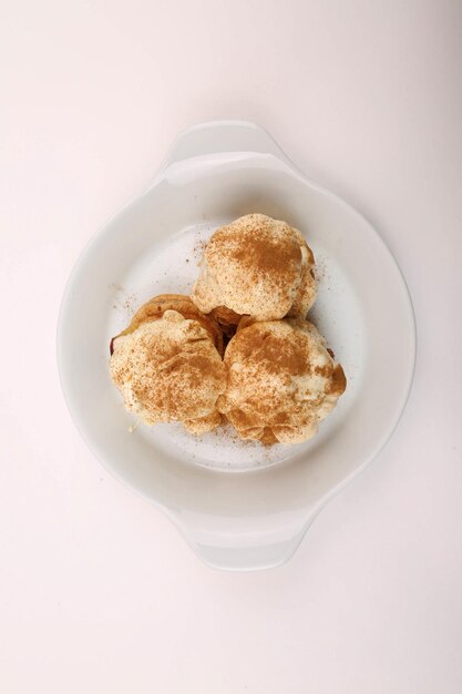 Delicious profiteroles with chocolate on the table