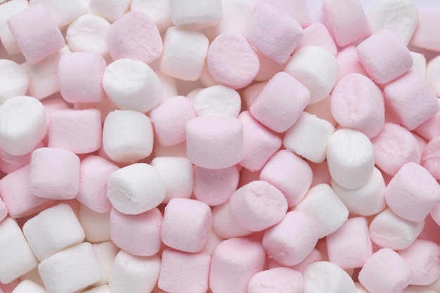 Delicious puffy pink and white marshmallows as background top view