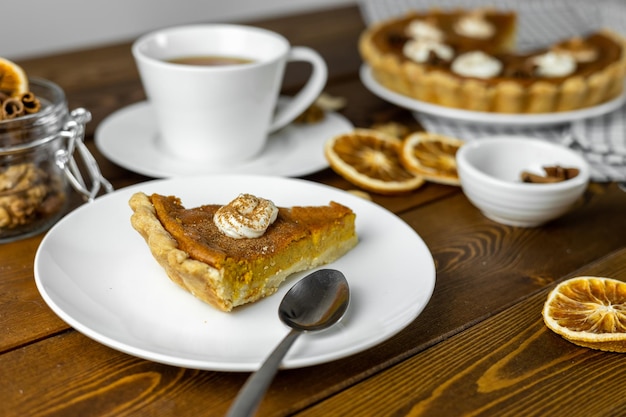 Delicious pumpkin pie thanksgiving day pie on wooden background