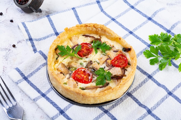 Delicious quiche with chicken meet mushrooms tomatoes and herbs