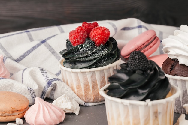 Delicious raspberry cupcakes on dark background - Handmade Sweet dessert