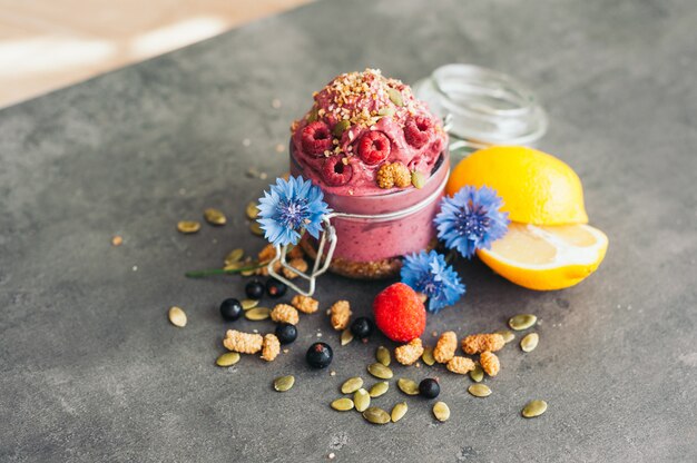 Delicious raspberry ice cream with pumpkin seeds and hempseed