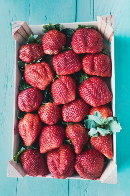 Delicious red and juicy strawberries Top view of a box with ripe strawberries