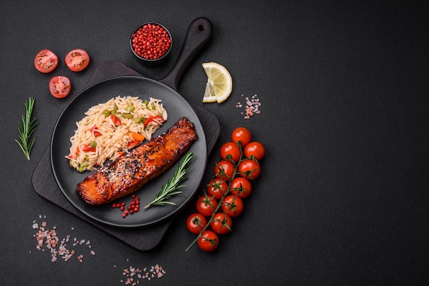 Delicious red salmon fish grilled with sauce and sesame seeds with rice and vegetables