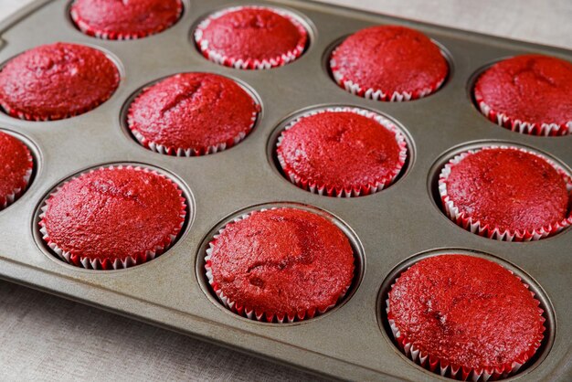 Delicious red velvet cupcakes in oven pen.