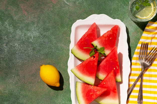 Delicious red watermelon in a plate top view copy space