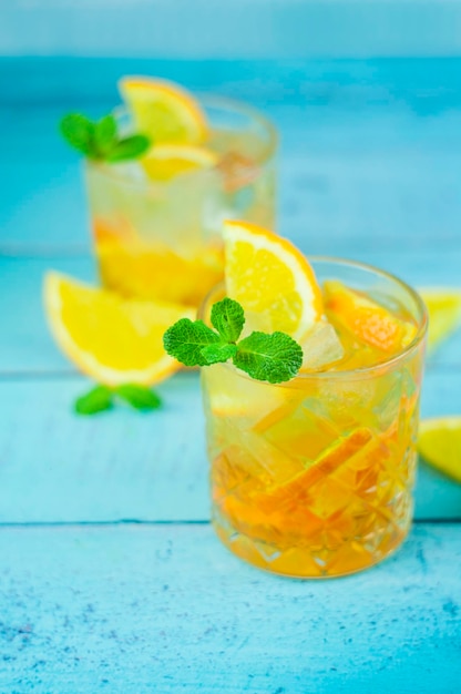 Delicious refreshing cocktail drink with alcohol and orange with mint leaf