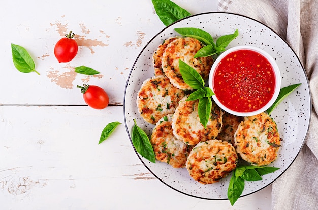 Delicious rice and chicken meat patties with garlic tomato sauce