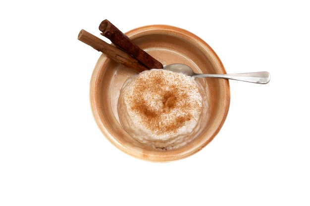 Delicious rice pudding with cinnamon isolated on white.