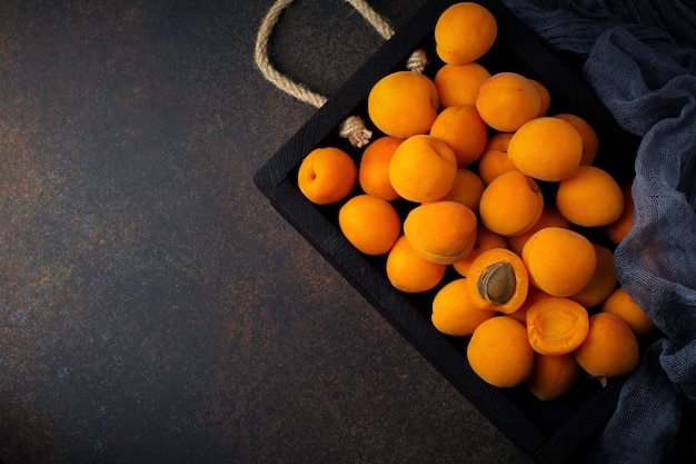 Delicious ripe apricots on a wooden stand  